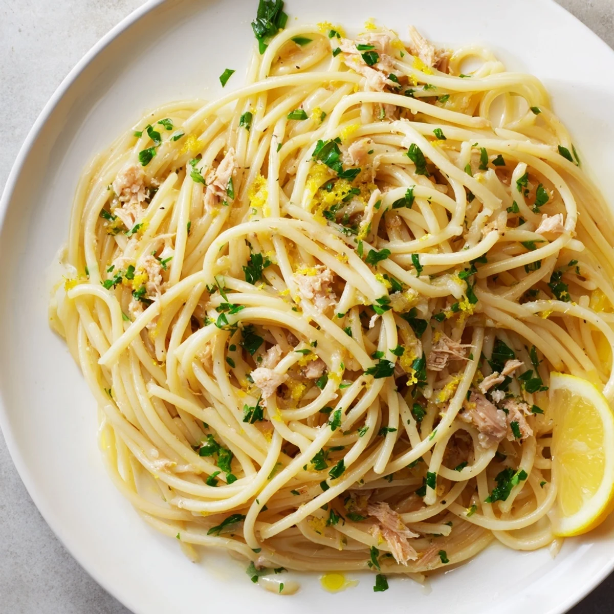 Close-up of freshly plated Lemon-Garlic Tuna Spaghetti, a simple pasta bursting with Mediterranean flavors.