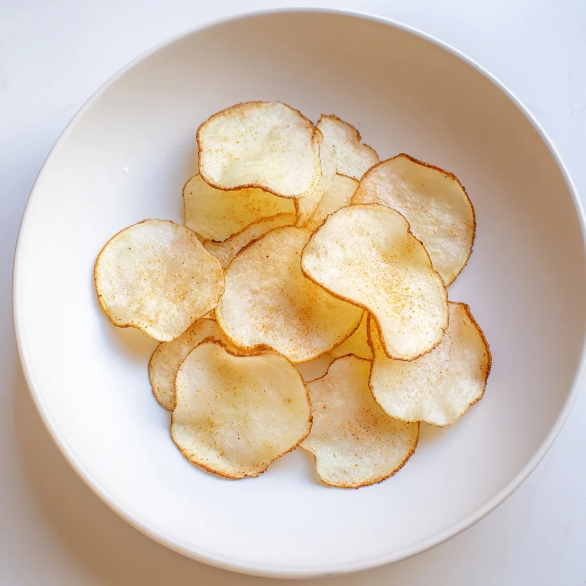 Air fryer potato chips: a pile of crispy, golden delights, seasoned and ready to eat as a snack.