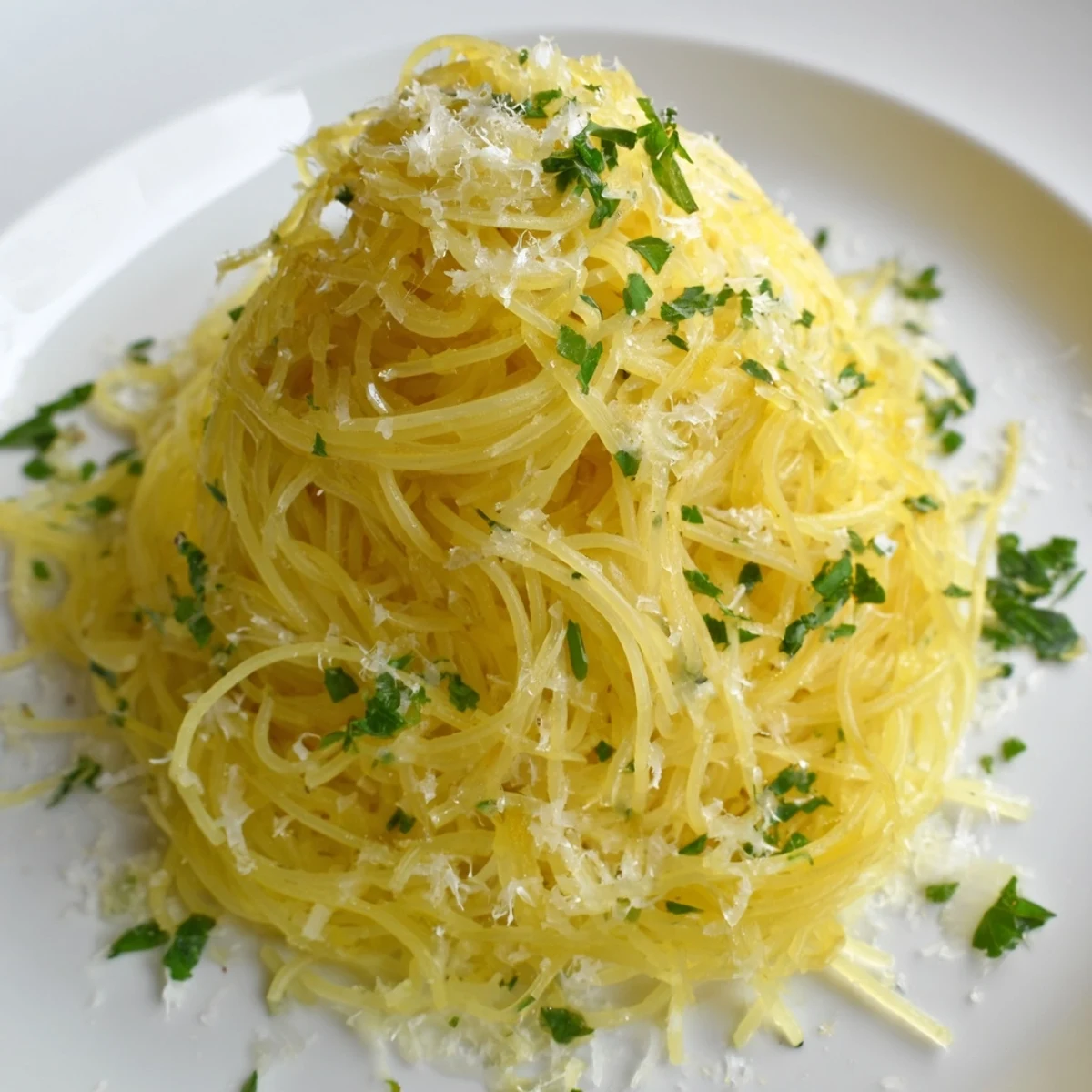 Golden, glistening Lemon Capellini with fresh herbs, ready for a flavorful, light dinner.