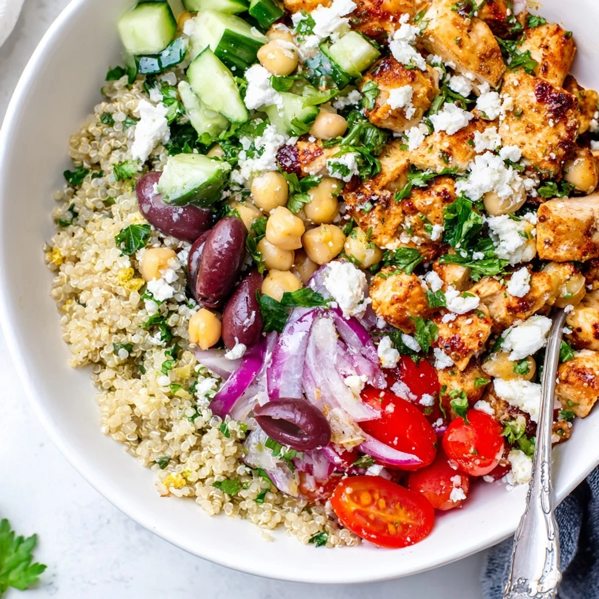 Brightly colored Mediterranean Chicken Bowl with juicy grilled chicken, creamy feta, crisp cucumbers, and fluffy quinoa in a ceramic bowl.