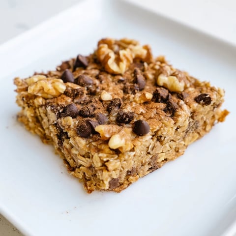 Golden Baked Oats That Taste Like Cake, a rectangular breakfast treat, ready to be sliced, smelling delicious.