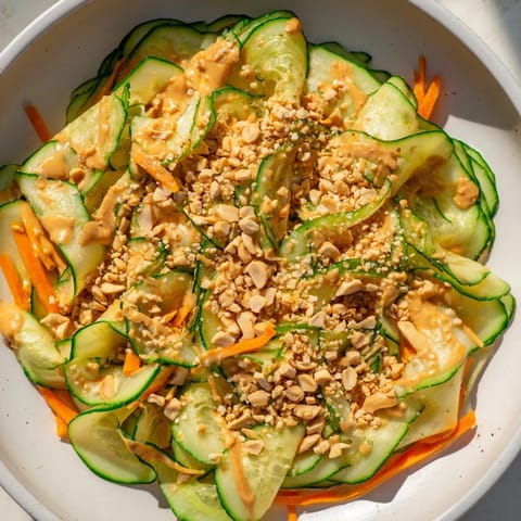 Vibrant Thai-Style Peanut Cucumber Salad, with crunchy cucumbers, carrots, and a creamy, peanut dressing.