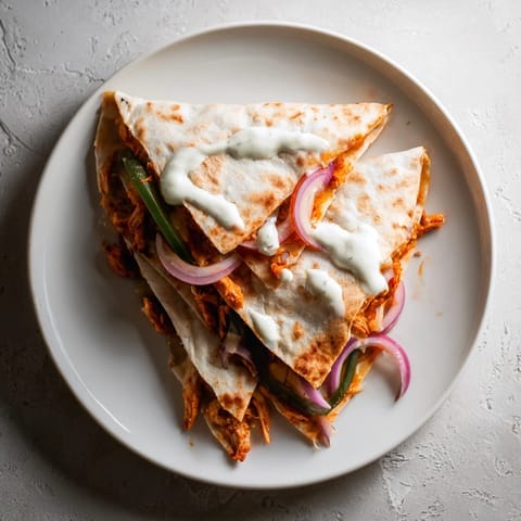 A close-up view of a delicious Tandoori Chicken Quesadilla, cooked until the tortilla is crisp.