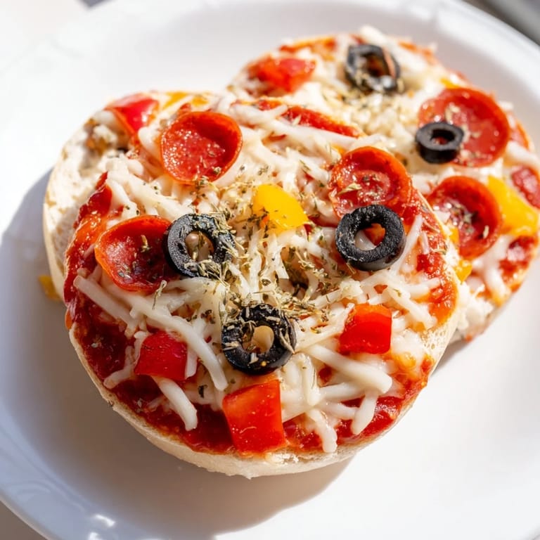 Freshly air-fried mini bagel pizzas with pepperoni and olives; a simple, satisfying appetizer.