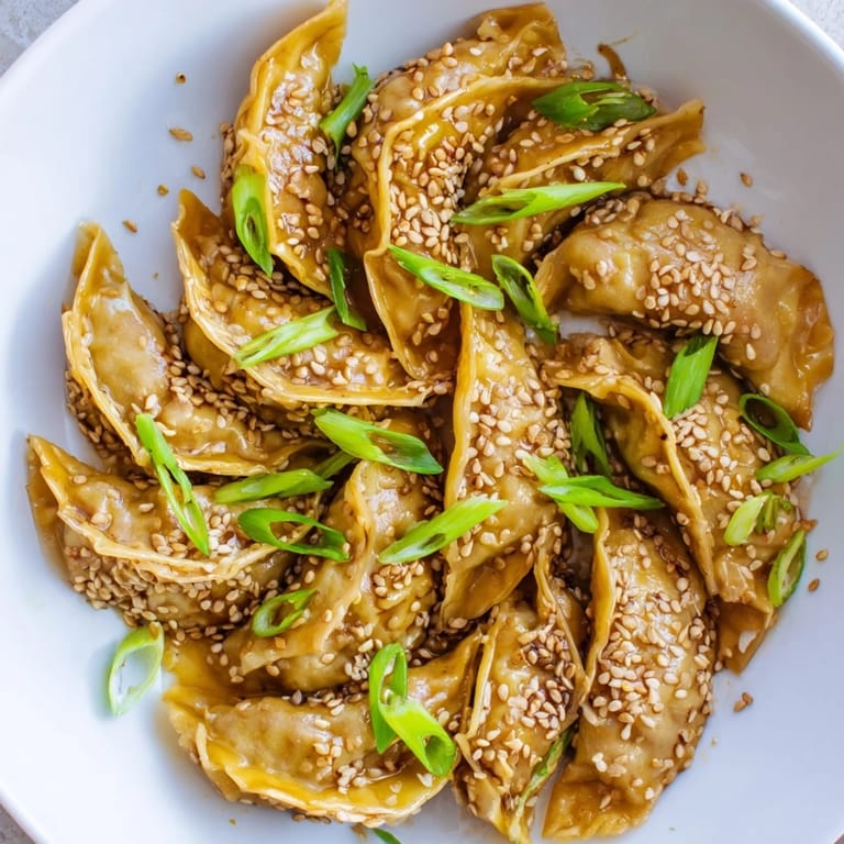 Enjoy a plate of perfectly air-fried frozen dumplings, with a sesame oil-infused glaze on top.