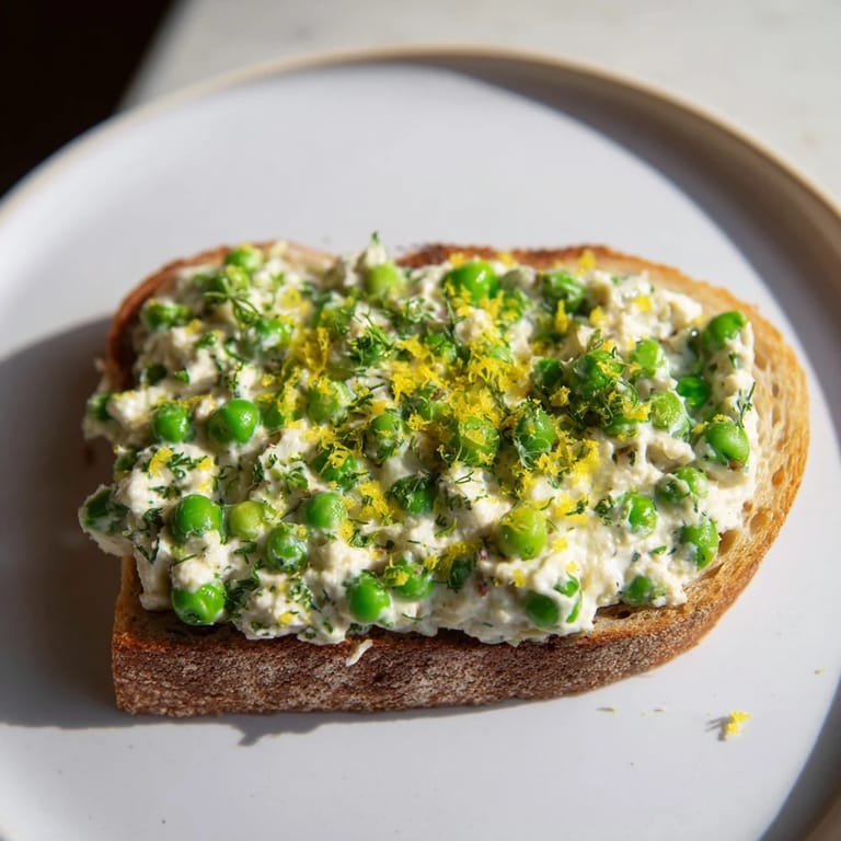 Crunchy sourdough with Pea & Mint Ricotta Toast, blended with sweet peas, mint, and olive oil, finished with zesty lemon.