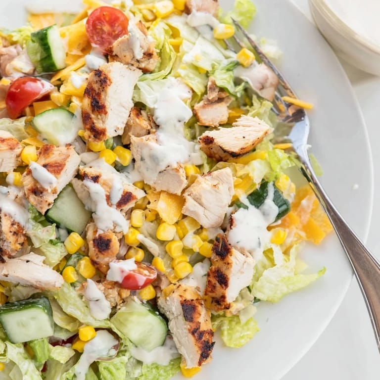 Ready to serve, this Ranch Chicken Chopped Salad makes a perfect lunch bowl with extra chives and a sprinkle of black pepper.
