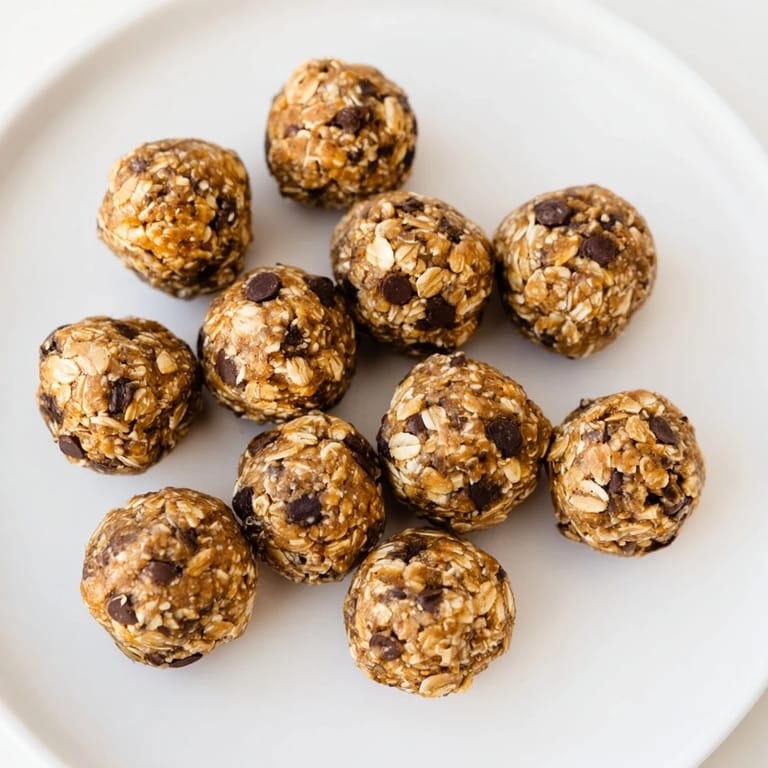 Banana Chocolate Chip Energy Balls piled in a clear glass jar, ready for a healthy on-the-go snack.  