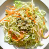Close-up view of Cabbage-Core Slaw Salad; crunchy shredded cabbage with a sesame-ginger dressing, ready to eat.