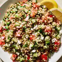 A colorful Tabbouleh Grain Bowl, with bright tomatoes and herbs, perfect for a fresh lunch.